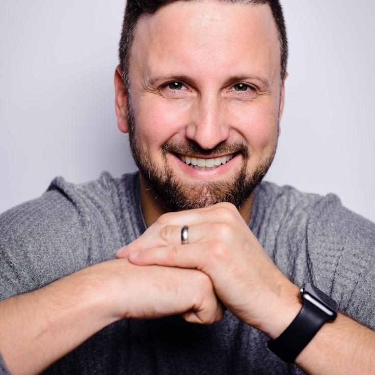 Alex Chen, Lead Design Curator at CalmGrovePlume, reviewing corporate floral arrangements